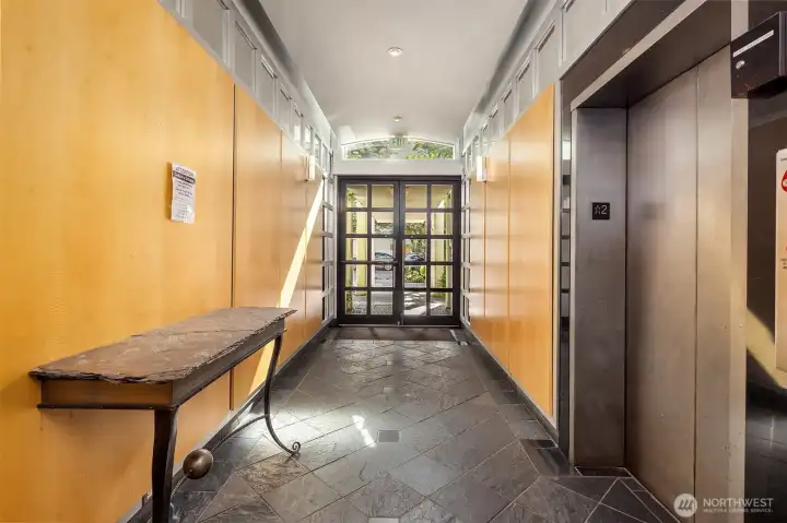 Secure fob entry to the Talisman with steel doors, elevator, slate floors, and wood-clad walls.