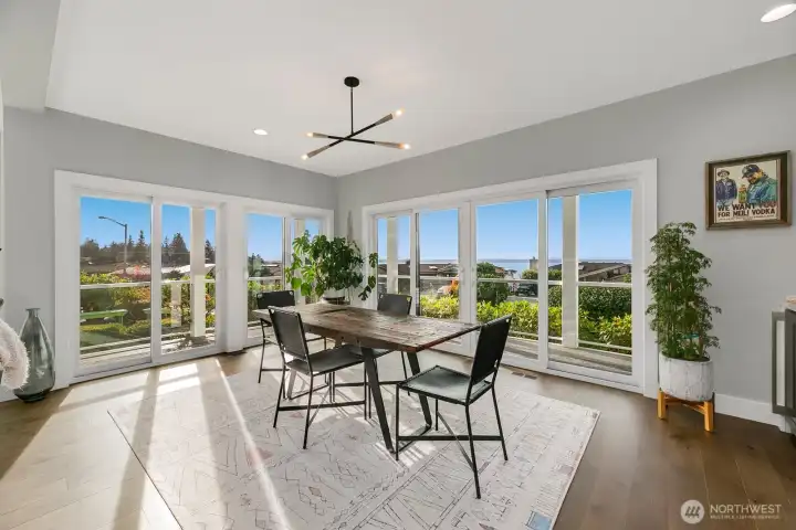 Formal dining room surrounded by light, windows, and views.