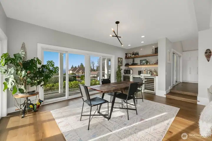 Custom dry bar with two solid wood floating shelves & three wine fridges.
