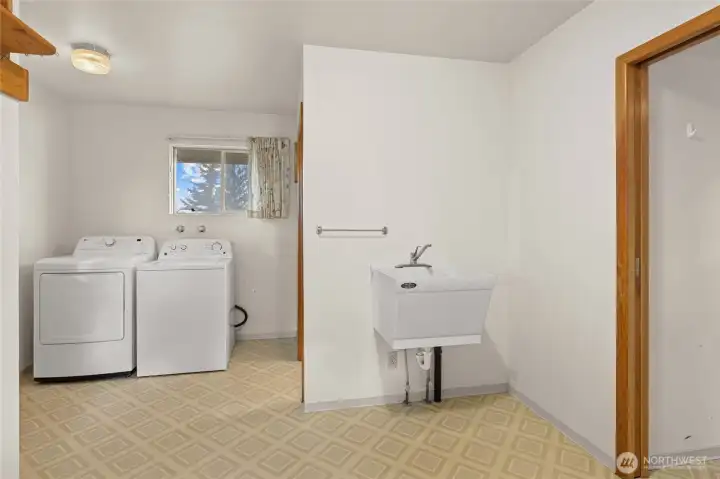 Huge utility room with a 1/2 bath, Easy access from the back of the home.