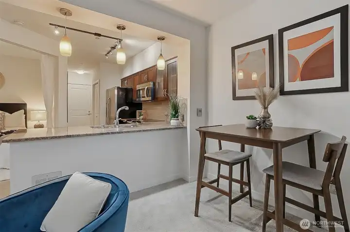 Looking back from the dining area to the kitchen and sleeping alcove.