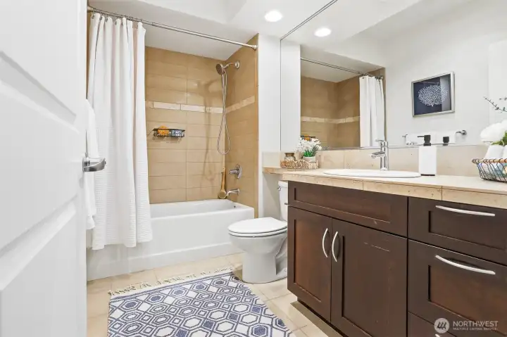 Large bathroom with tiled shower enclosure.