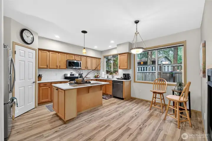 The updated kitchen features quartz counters/backsplach, newer appliances and a walk in pantry.