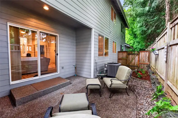 Relax on your private patio with a small flowerbed.