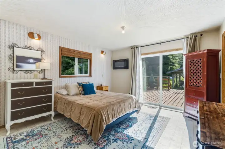 Primary ensuite bedroom with sliders to the deck