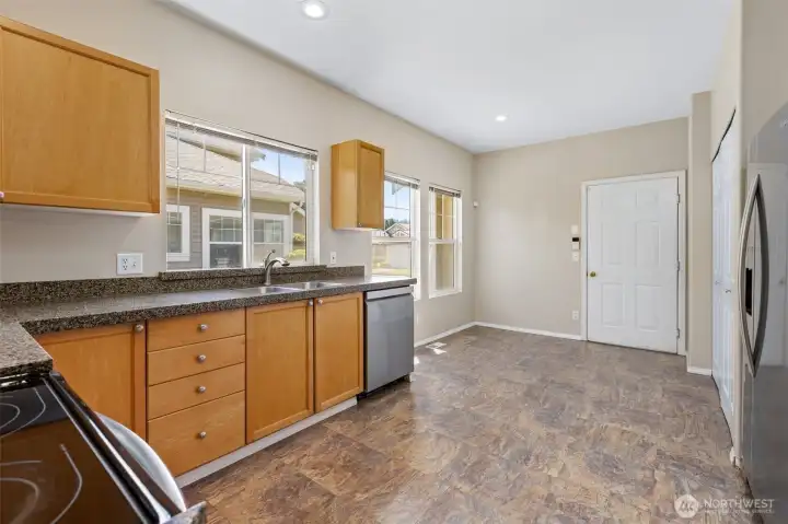 Spacious kitchen with eating area connecting to garage