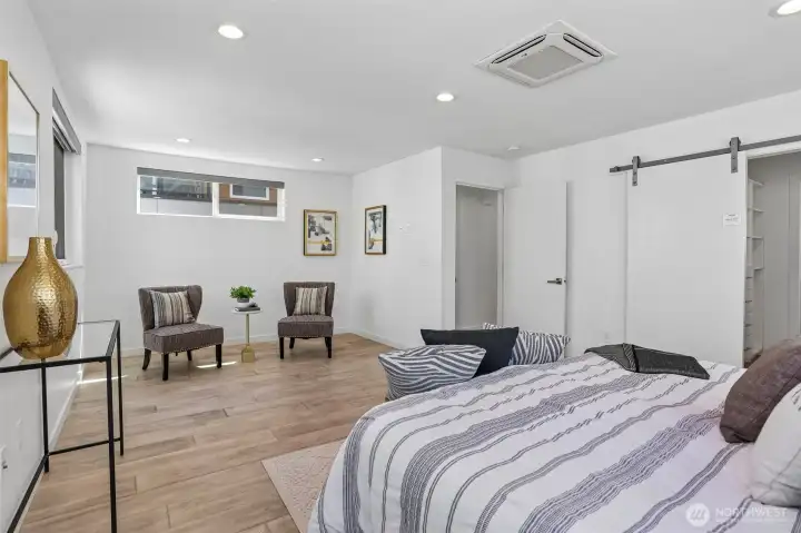 Oversized and air conditioned primary suite with sitting area, spacious custom closet, and heated tile floors in the primary bath. Oversized and air conditioned primary suite with sitting area, spacious custom closet, and heated tile floors in the primary bath.