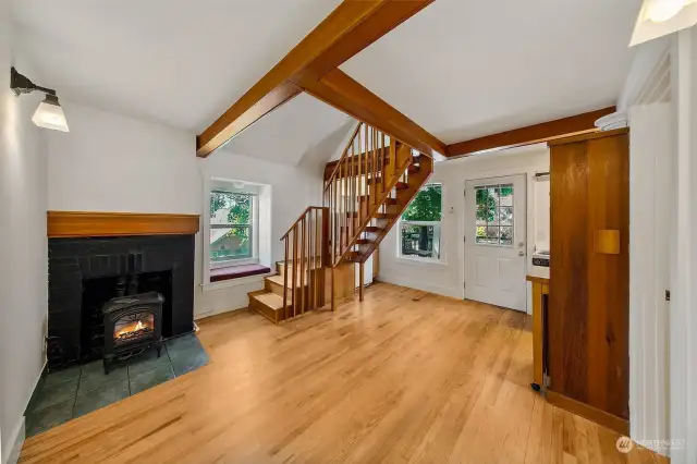 Apartment #7 - On the second floor with a small deck area, apartment 7 features oak floors, small kitchen, full bathroom and repurposed storage hutch from an area houseboat with built in garbage container, chopping block, and storage cabinet with glass doors. Follow the timber frame stairs up to the spacious sleeping loft.