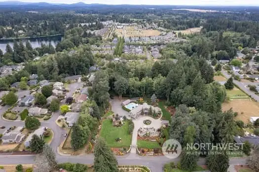 LOOKING SOUTH --- Upper end home in front w circular driveway & pool.