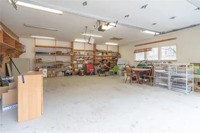Very large garage has built-in shelves.