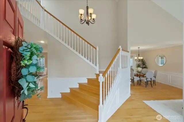 Step inside to the dramatic two-story entry and admire the hardwood floors