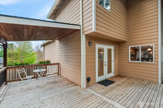 The backyard deck is partially covered - perfect for an eating area or relaxing on a summer day