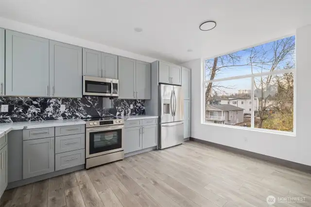 This kitchen showcases the lay out and high-quality finishes you can expect in the newly constructed home at 8608 & 8610 42nd Ave S, Seattle, WA 98118, built by the same builder.
