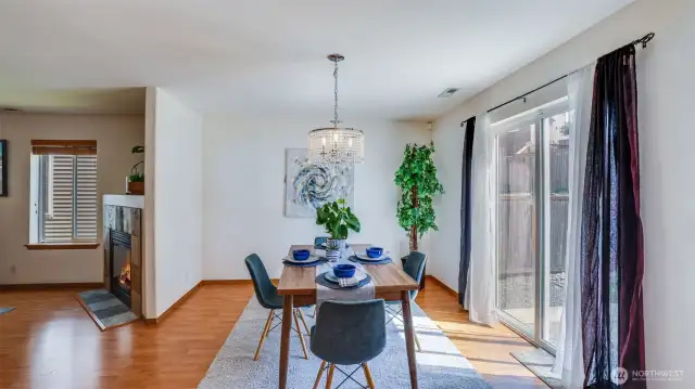 This dining space, with a back door leading to the backyard, is filled with natural light, creating a warm space for you and your guests