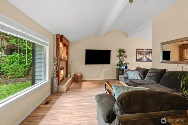 Large picture window and vaulted ceilings.