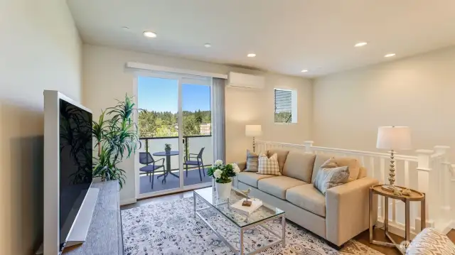 The family/living room from a different view.  The view of the room shows a Lennox mini split.  There are additional wall heaters in the home.  In the garage there is a very efficient tankless water heater.