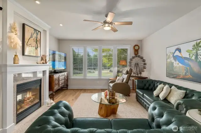 Family room/den is nice and bright, courtesy of a large bank of windows with plantation shutters