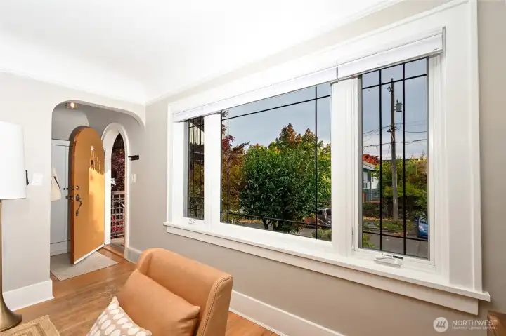 Entry has big windows and hardwood floors.