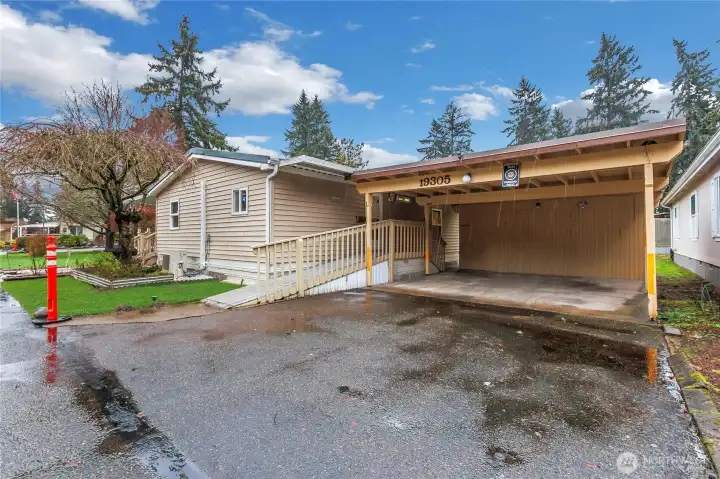 Back of home, easy access and covered parking for two cars.