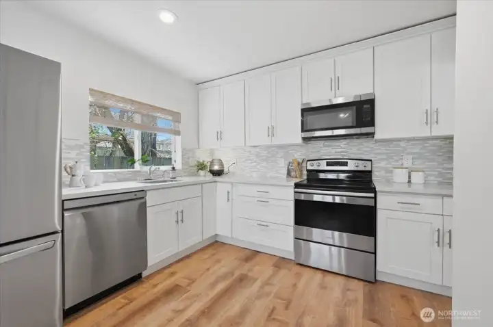 Nice size kitchen updated in 2017 with new cabinetry, quartz counters and Stainless steel appliances, though appliances (Fridge, Dishwasher & Garbage disposal have all been recently upgraded/replaced