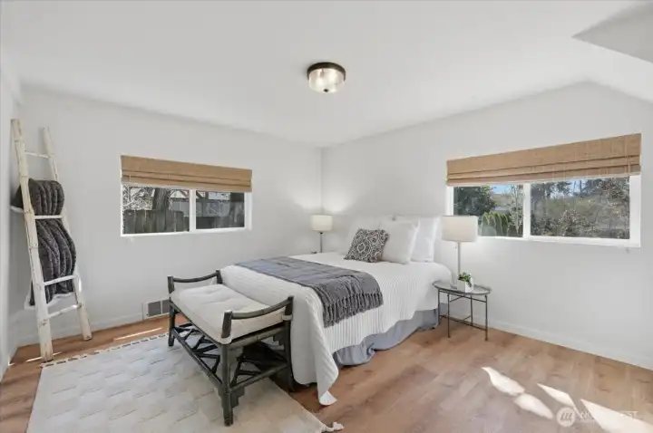 Light floods this nicely sized primary bedroom - bathroom just steps from the door