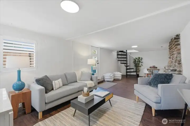 Lower level offers hard flooring surfaces, plenty of room for living and dining with plumbing to this room as well with sink/vanity already installed.  Easy to add more cabinetry/counter to make kitchen area if desired