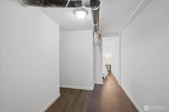 Showing walk through storage area to laundry room.  This area is great added storage, and or could be easily turned into dressing area, extended closet space, great spot for a vanity and mirror, or even small gym