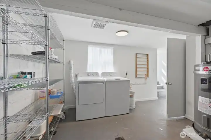 Large laundry area (washer & dryer & shelving racks stay.  This room also houses the gas furnace installed 2017 & 50 gallon electric hot water heater with expansion tank (brand new - installed 3/2026.  This room is accessible by back door making a potential shared laundry room easy, if desired
