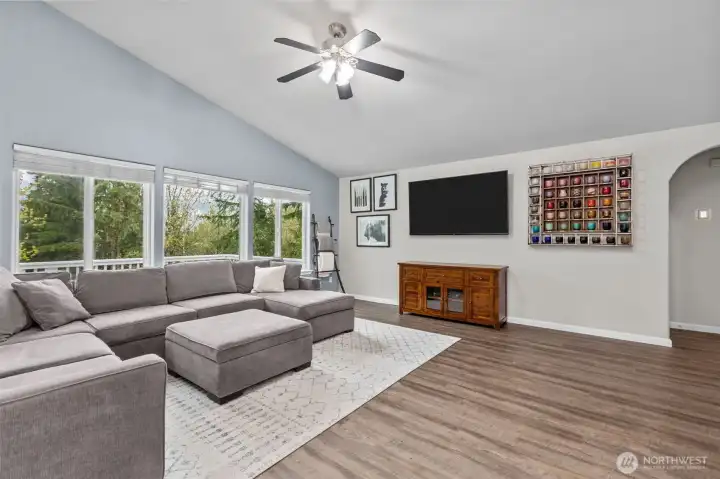 Bright and inviting living space with vaulted ceilings.