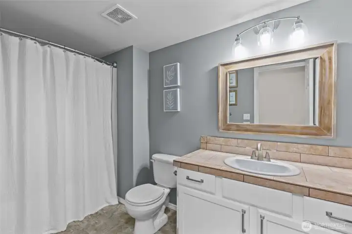 Full bathroom, located on the lower floor.
