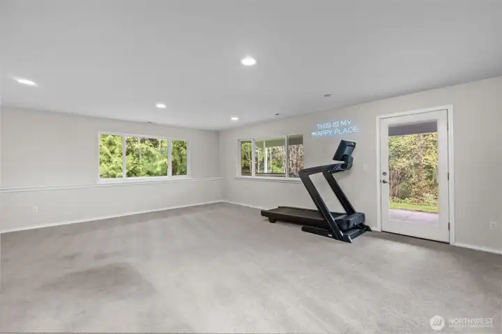 Spacious rec room perfect for a home gym or movie room.
