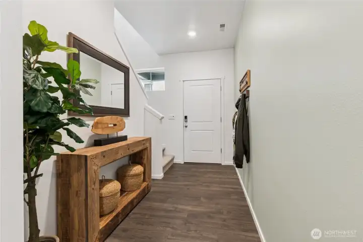 Large foyer perfect for a bench or coat rack. Actual home is under construction and finishes, materials, and colors will vary. See site agent for details.