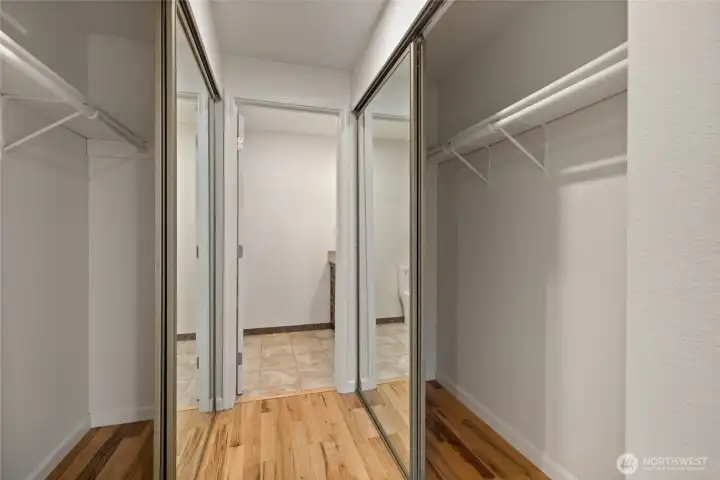 Closets on both sides leading to the primary bathroom