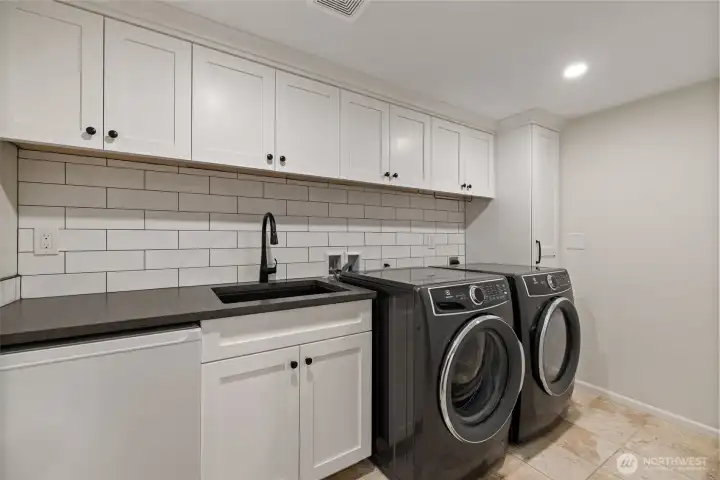 Laundry room has brand new washer and dryer plus a fridge and tons of counter space