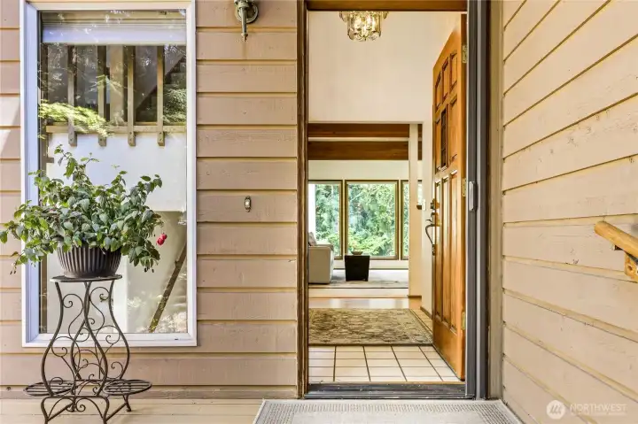 Covered entry leads to tiled foyer
