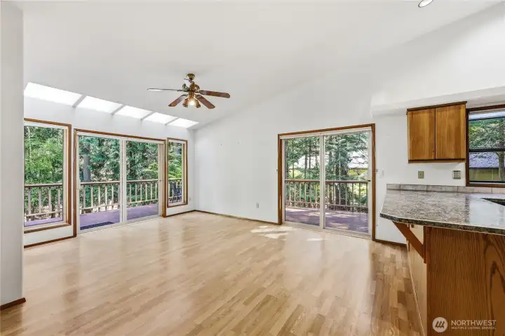 Light-filled dining area open to kitchen with bar seating.
