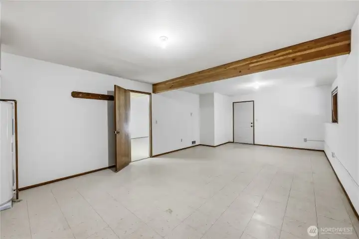 At the other end of the hall, just off the family room/lower kitchen area, is this large room which has its own entrance from the back yard.