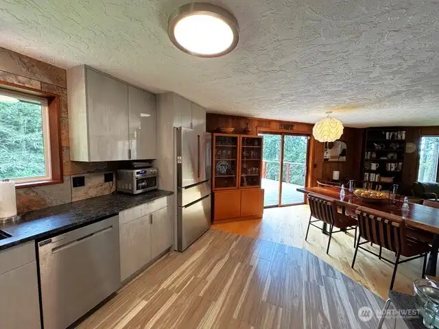 Granite counters, with porcelian tile back  splash, induction stovetop over convection oven, includes air fryer too. Mediterranean stone custom cabinetry