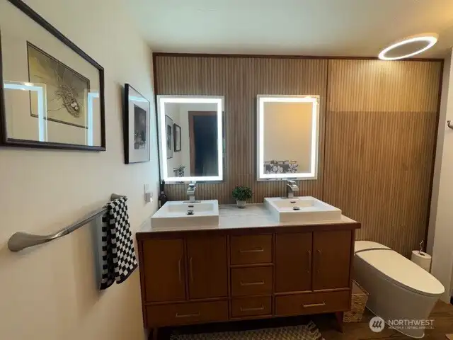 Luxurious bathroom with custom teak cabinetry, smart toilet with bidet, porcelain wall tile, anti-fog mirrors, exhaust fan can connect music from your smart phone