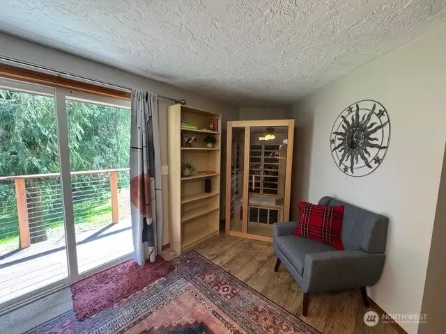 Personal infrared sauna completes the sitting area in primary bedroom.