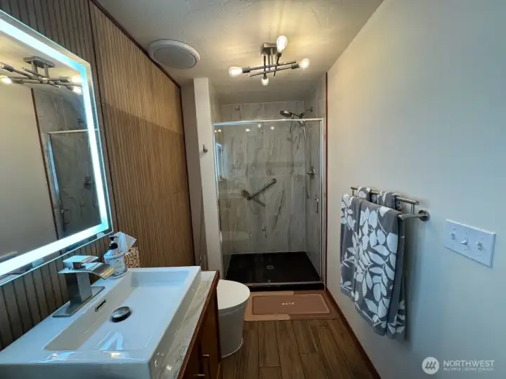 Marble like stone graces the shower.