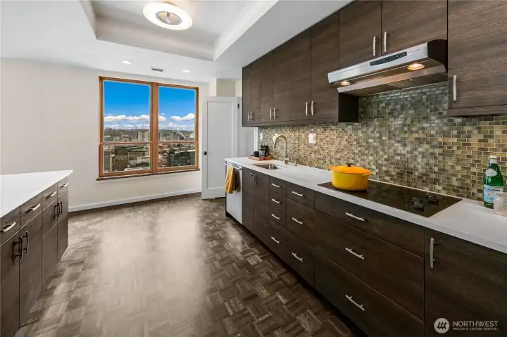 Generous work surfaces and integrated appliances support cooking and entertaining within the penthouse kitchen. Generous work surfaces and integrated appliances support cooking and entertaining within the penthouse kitchen.