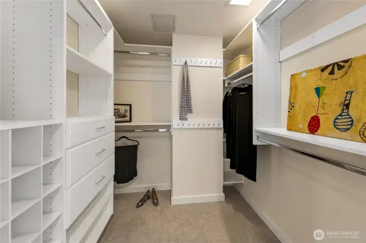 A custom dressing room supports organized storage within the penthouse primary suite. A custom dressing room supports organized storage within the penthouse primary suite.