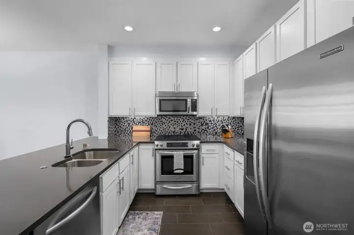 New quartz, backsplash, and SS appliances.