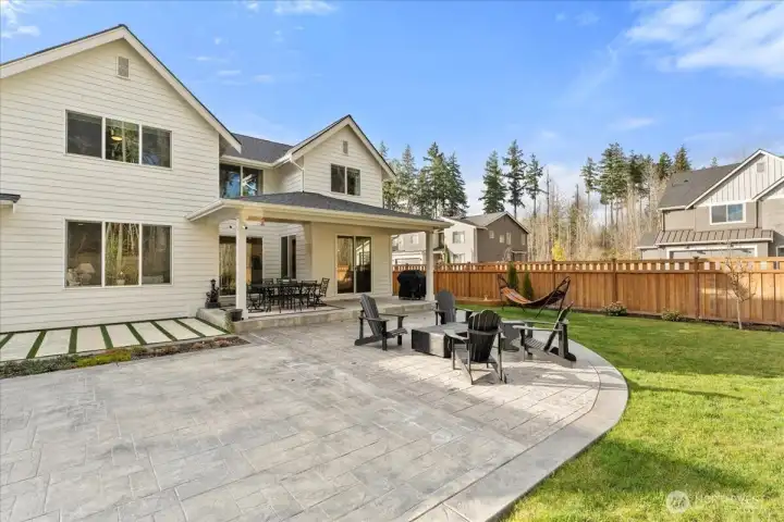 Another angle of the covered outdoor retreat the impressive stamp concrete extended patio and the hardscape concrete with artificial turf. If you are looking for a home that has it all, interior and exterior you have found it here in this home.