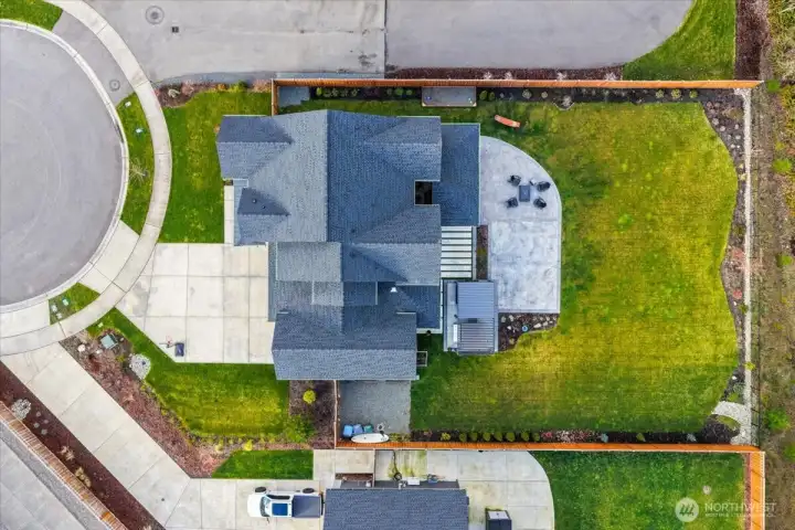Aerial view of this home on the premium 17,010 fully fenced private lot.