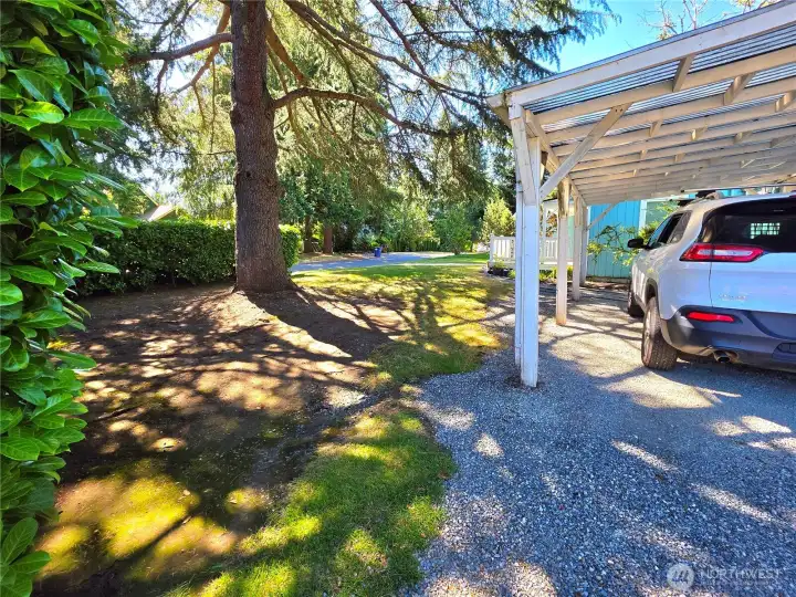 Car port with entry door to the right under cover