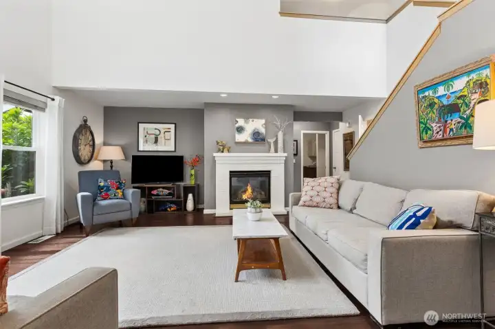 Take the chill off the great room space with the cozy gas fireplace with white brick surround and hang your art, big screen in the large recess. Easy access to the Primary bedroom, laundry/garage, half bath and stairs up right. Take the chill off the great room space with the cozy gas fireplace with white brick surround and hang your art, big screen in the large recess. Easy access to the Primary bedroom, laundry/garage, half bath and stairs up right.
