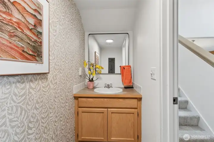 A convenient half bathroom offers a tidy offering always ready for guests while the primary bath and upstairs bath meet the household needs. A convenient half bathroom offers a tidy offering always ready for guests while the primary bath and upstairs bath meet the household needs.