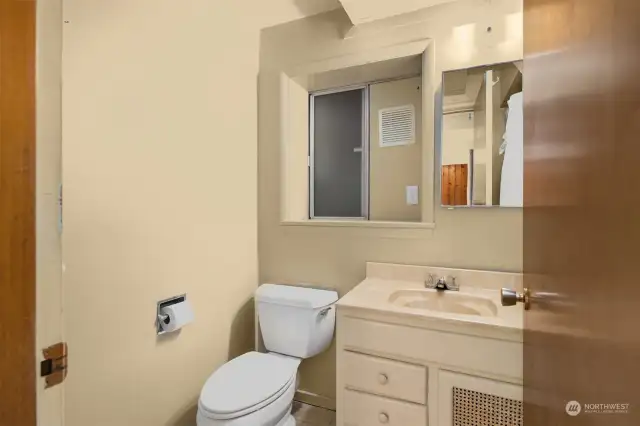 Convenient to the slider leading to the beach, is another bath with shower.